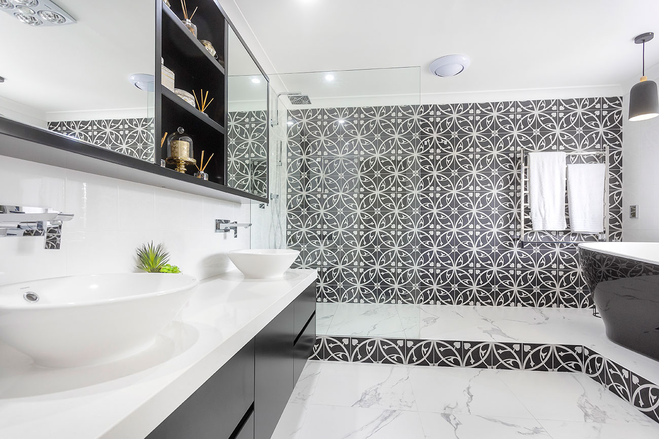 Luxury Bathroom Design with a black cabinet and two white marble basins