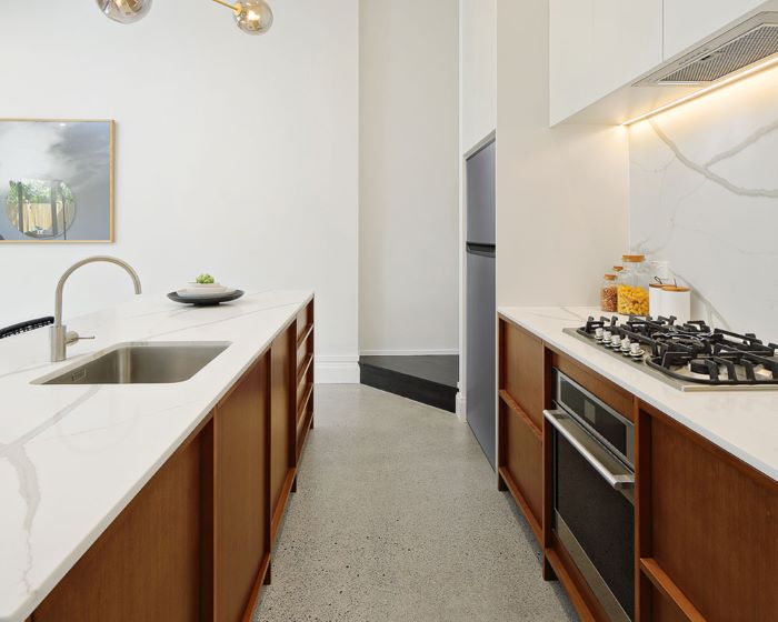 A modern white veneer kitchen with custom handles in Leichhardt, Sydney