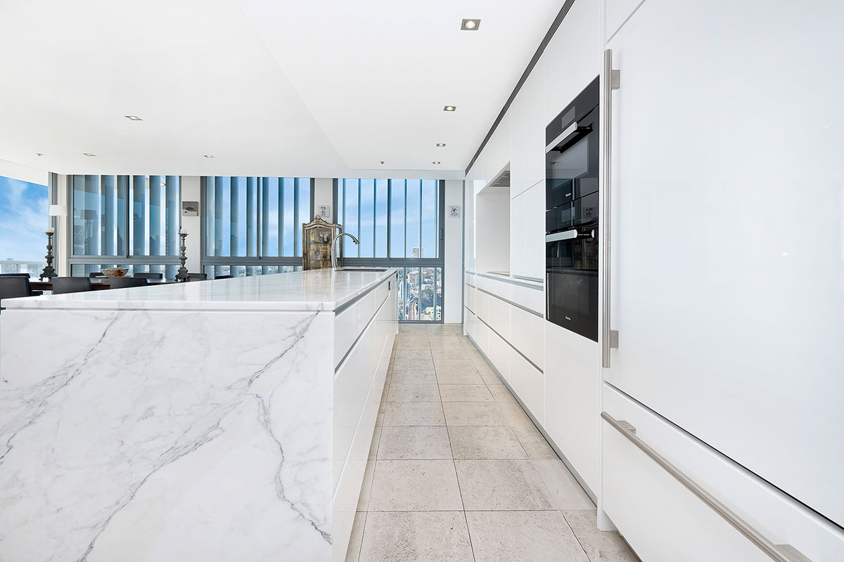 A Rushcutters Bay kitchen design with wooden cabinetry and a marble backsplash